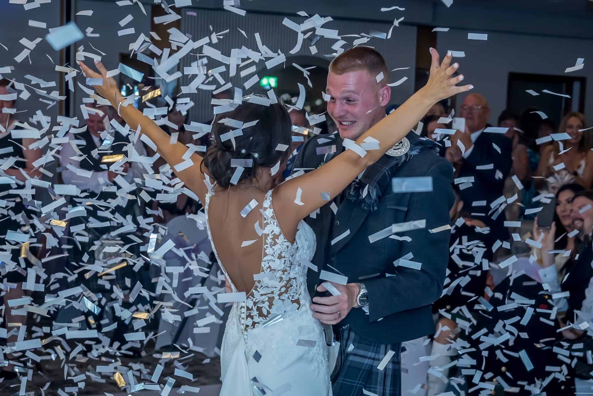 Bride and groom celebrating under confetti at a Gailes Hotel wedding