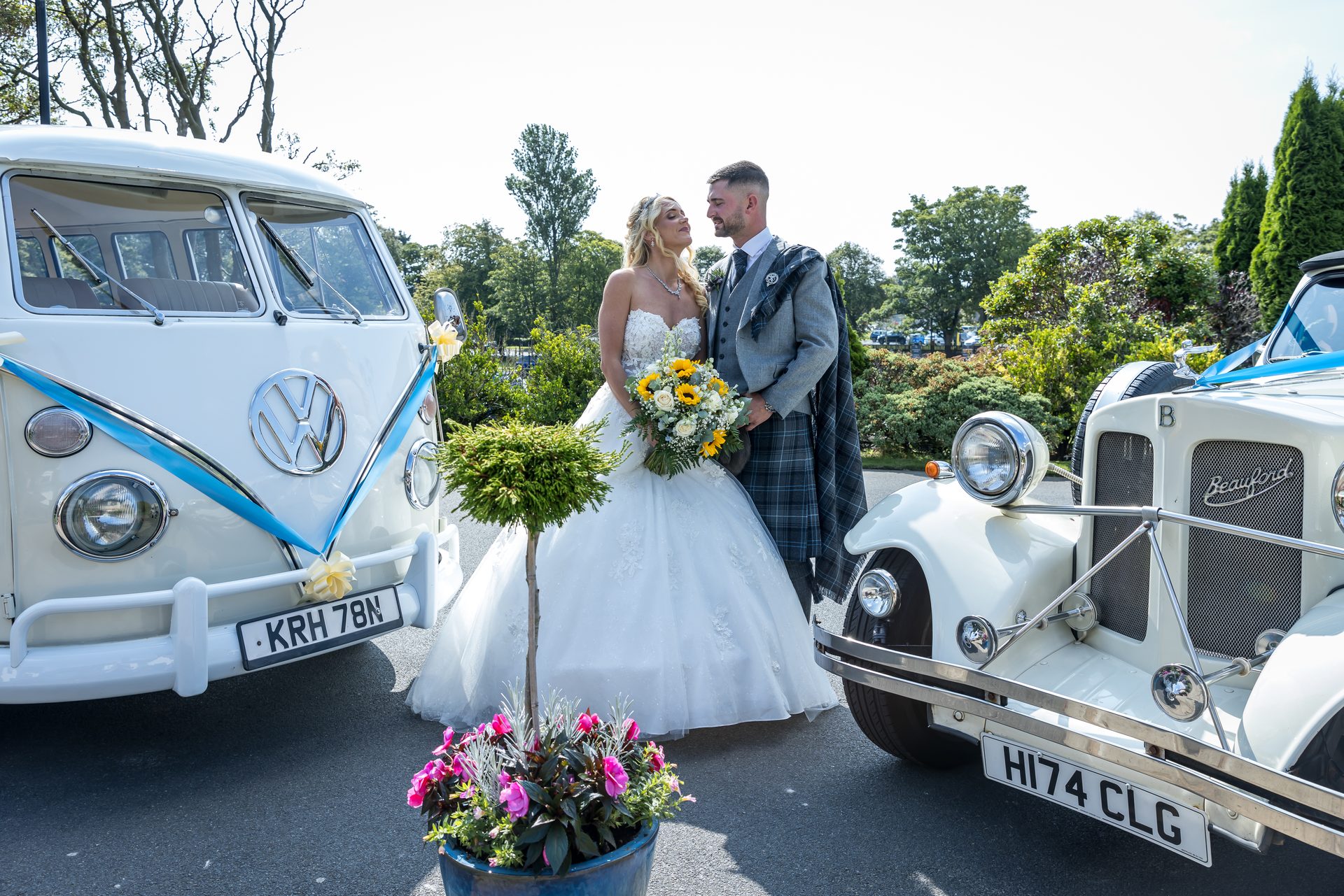 Bride and groom with their wedding cars at Western House Hotel in Ayr