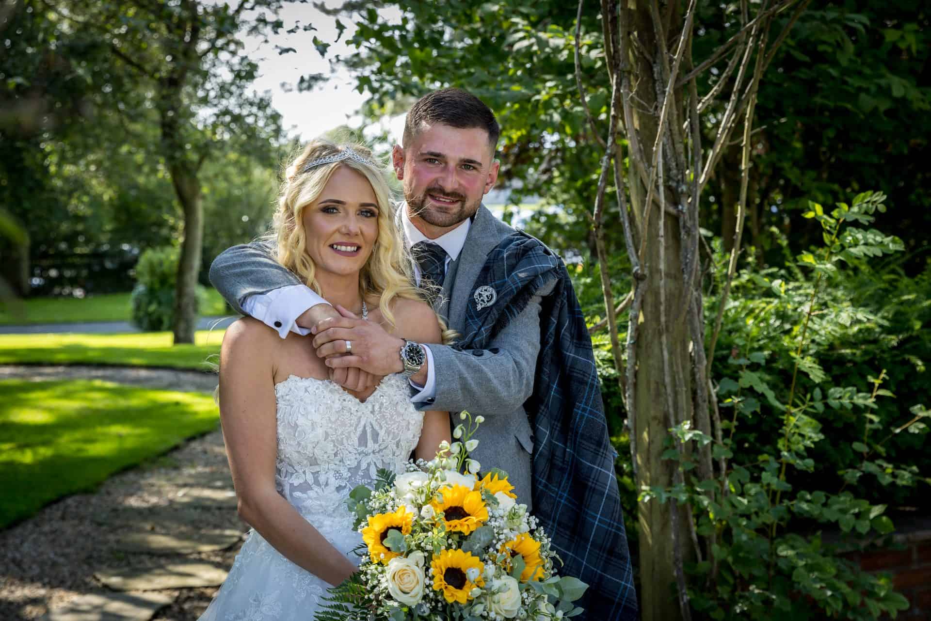Bride and groom walking through the tree-lined grounds at Western House Hotel